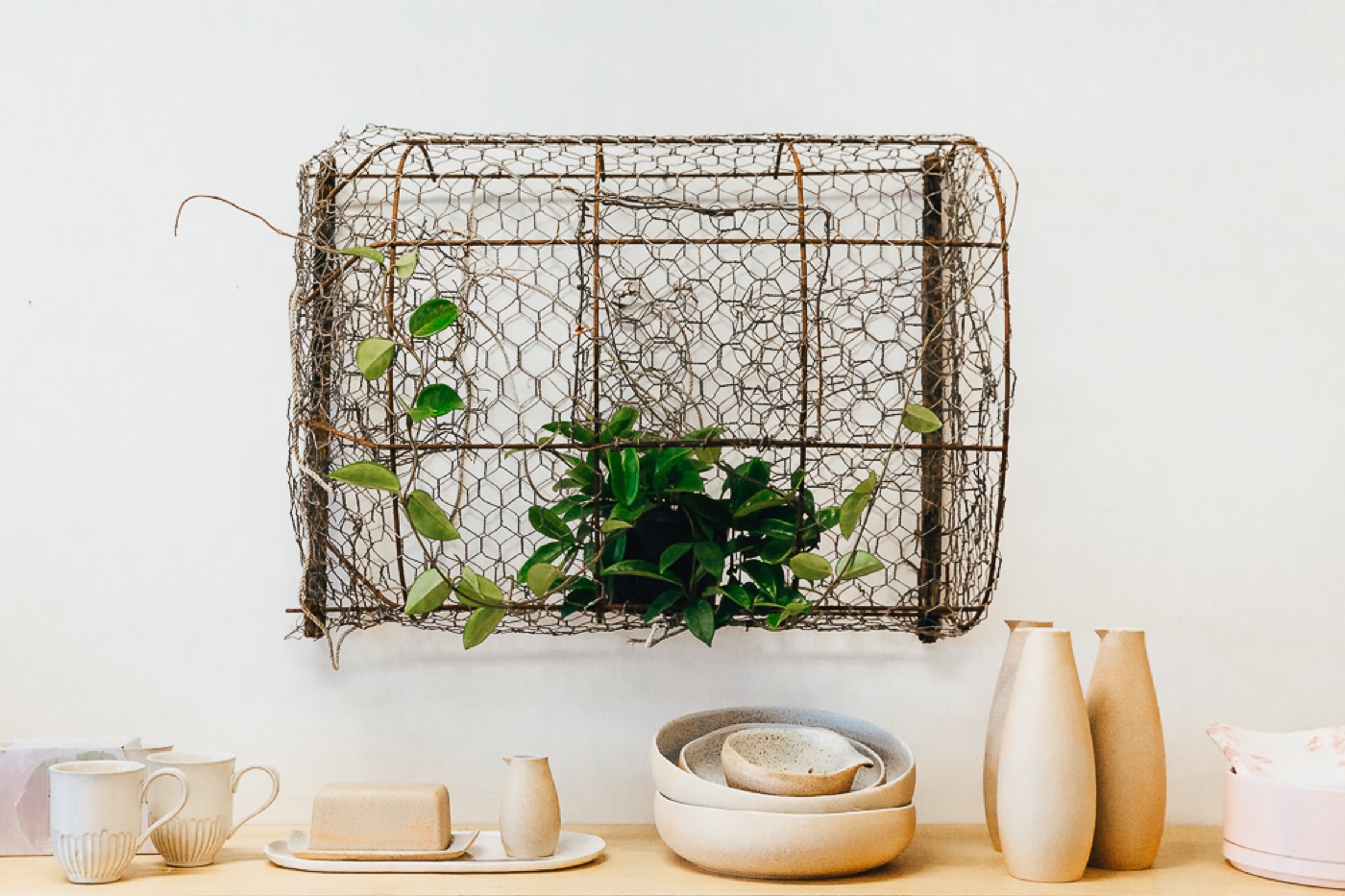 Handmade ceramics and vases on a timber shelf